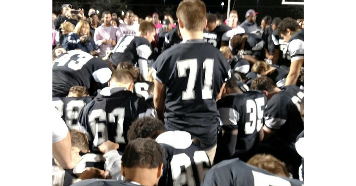 A group of young men in football uniforms.