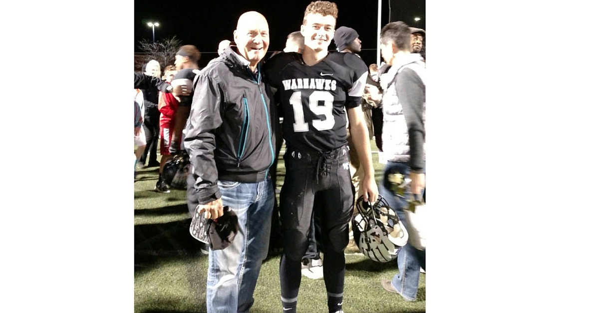 A man and a boy standing next to each other.