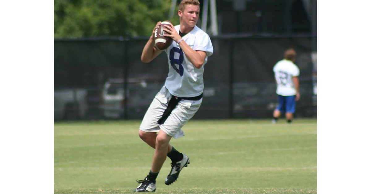 A man holding a football in his hand.