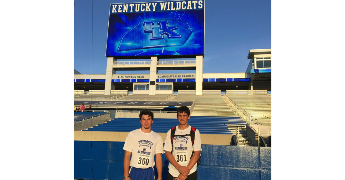 Two men standing in front of a stadium.