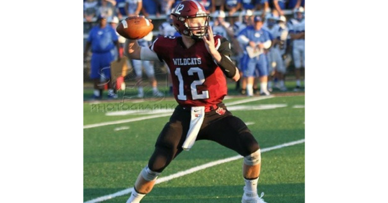 A football player is throwing the ball