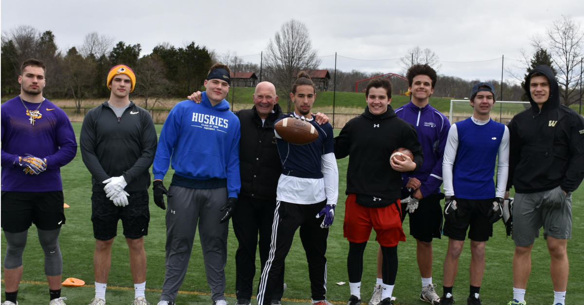 A group of men standing on top of a grass covered field.