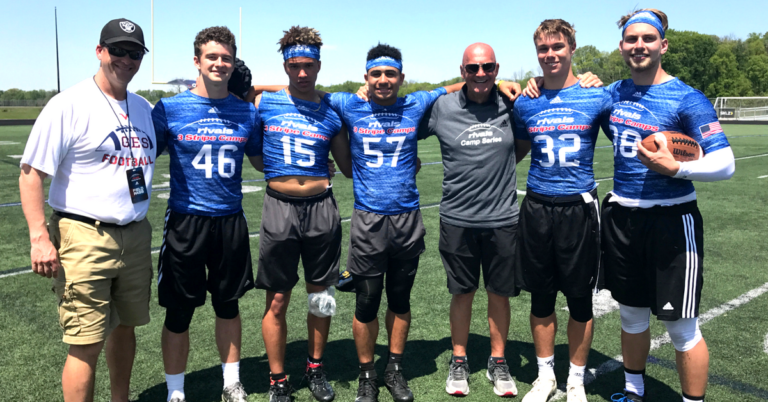 A group of young men standing on top of a field.