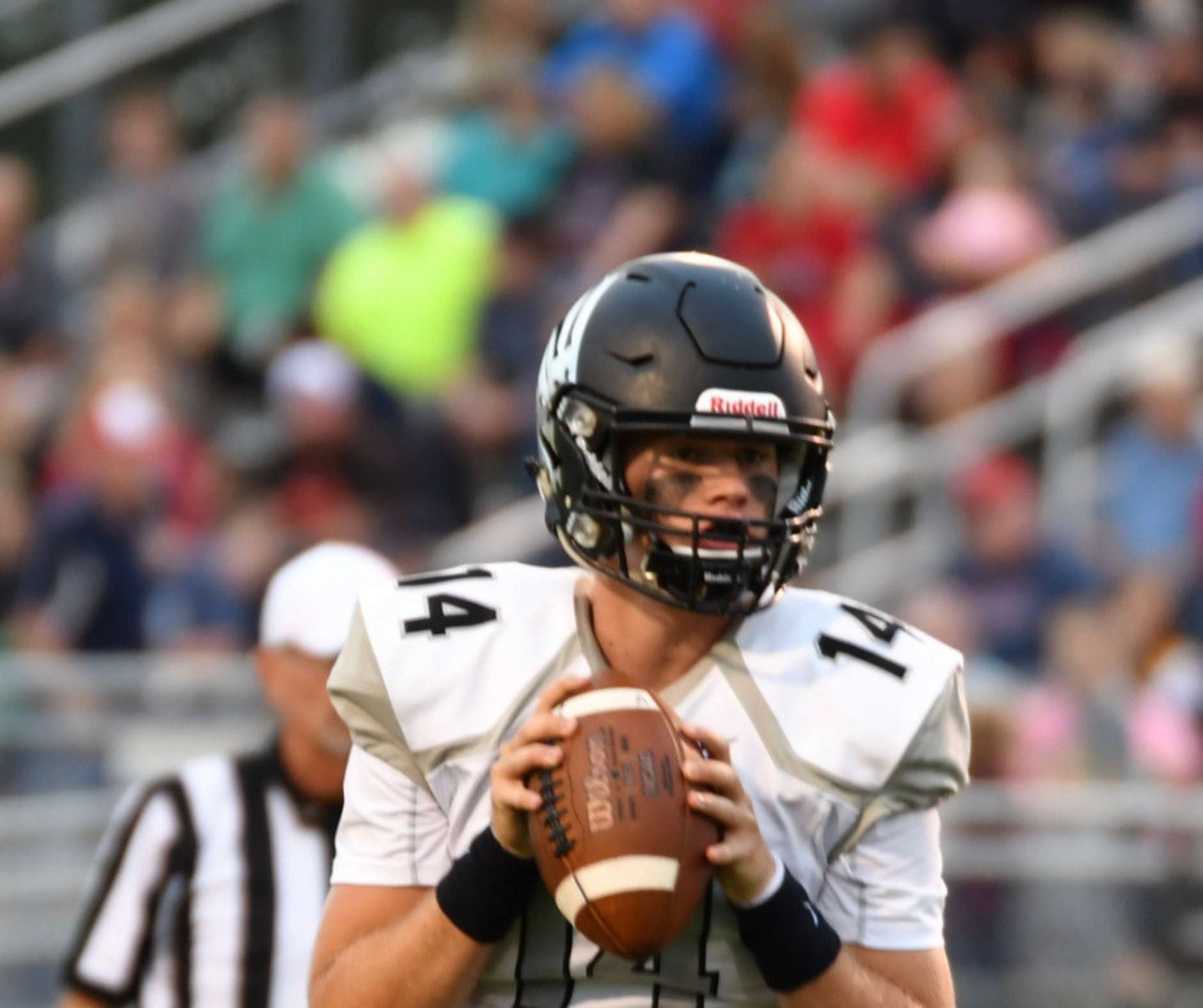 A football player holding a ball in his hands.