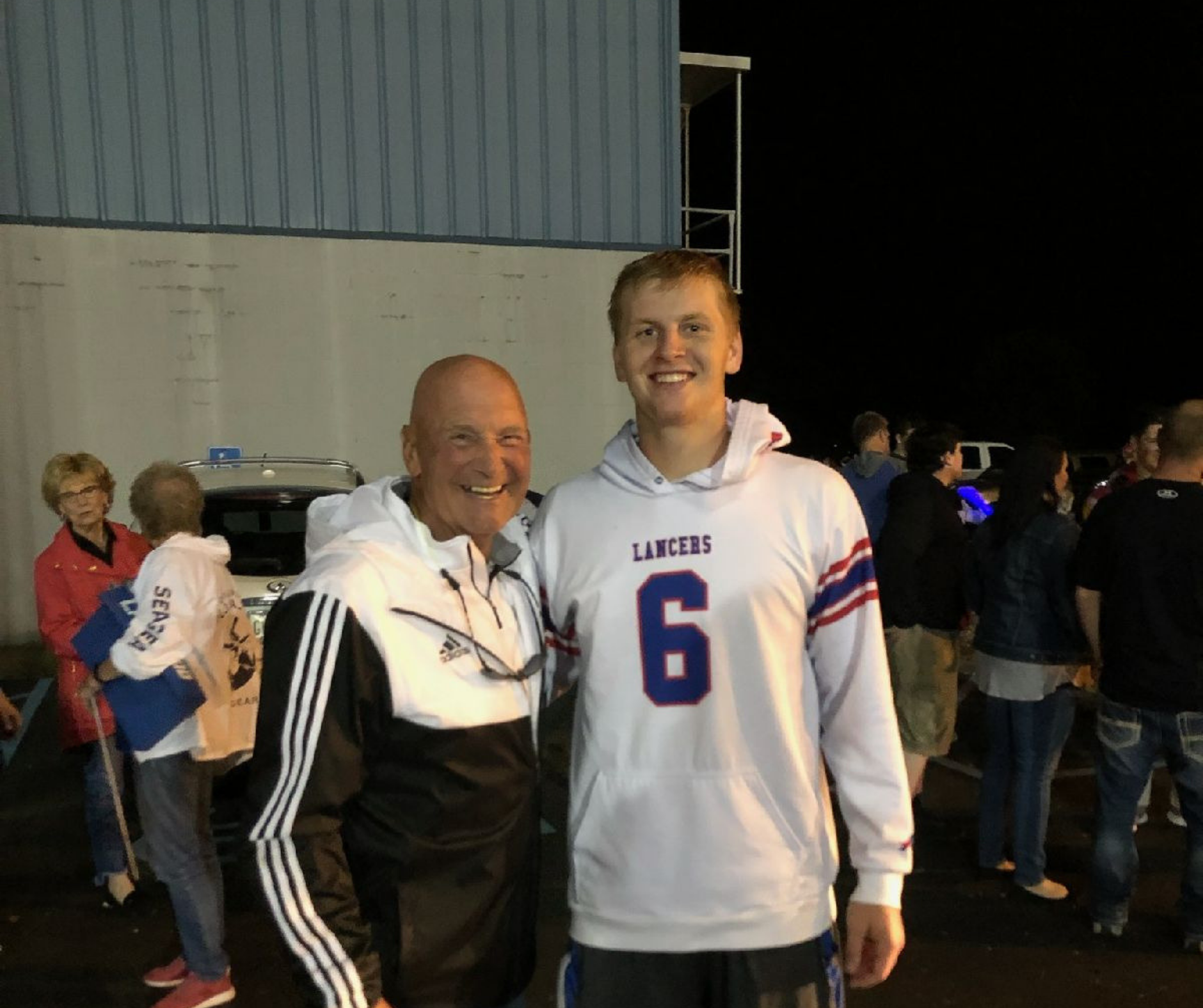 A man and a boy standing next to each other.