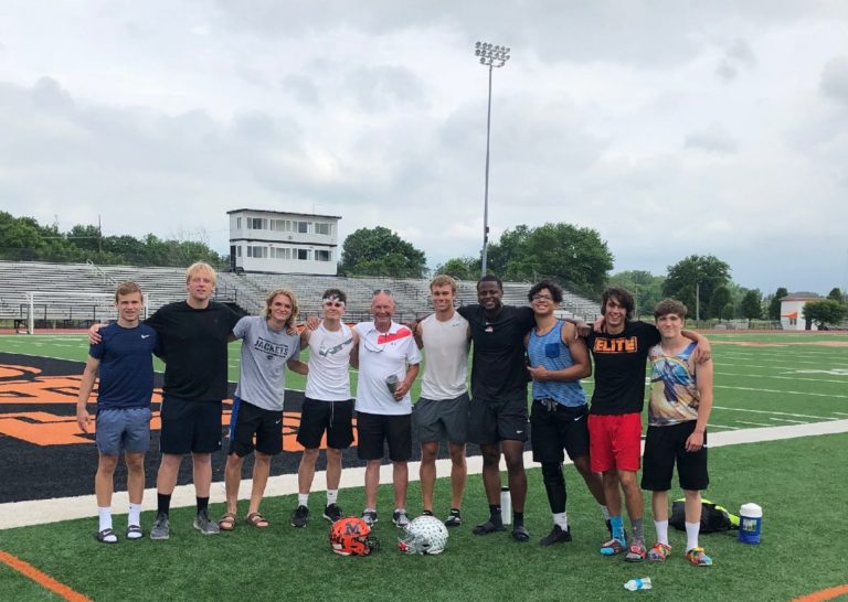 A group of people standing on top of a soccer field.