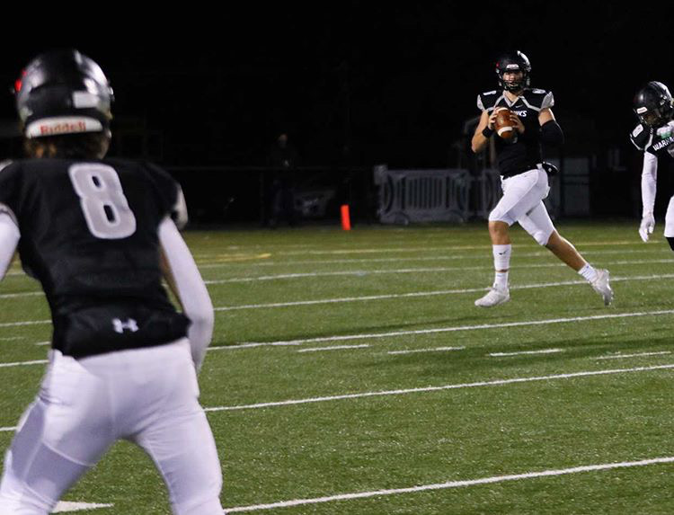 Two football players are playing on a field.