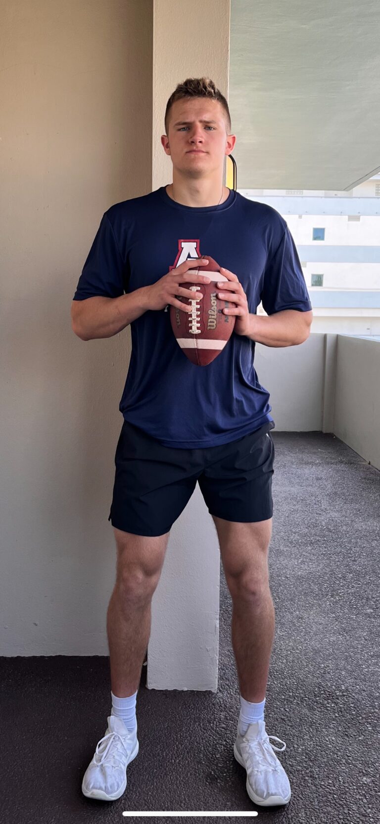 Player Matt Carlisle with a Football in his hands