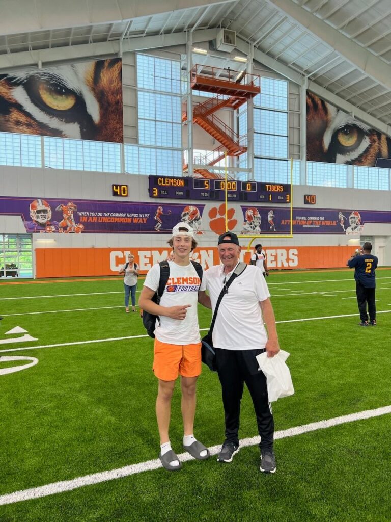 a boy and an elderly man posing for a picture